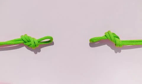 Two ropes with secure knots. climbing rope with a knot lies on a colored back Stock Photos