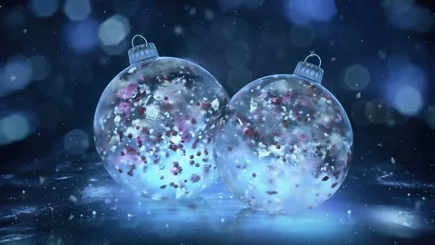Two Rotating Christmas Blue Ice Baubles snow colorful petals background loop Stock Footage 82436279
