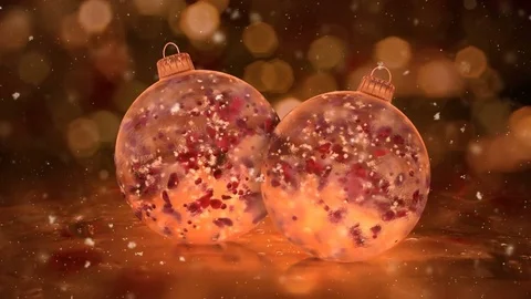 Two Rotating Christmas Golden Ice Glass Baubles snow red petals background loop Stock Footage 82437675