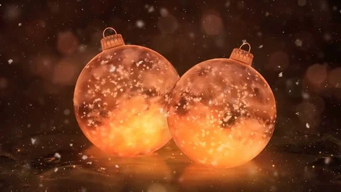 Two Rotating Christmas Golden Ice Glass Baubles Decorations snow background loop Stock Footage 82437764