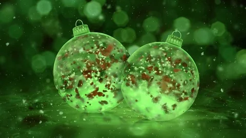 Two Rotating Christmas Green Ice Glass Baubles snow red petals background loop Stock Footage 82438332