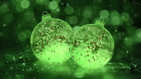 Two Rotating Christmas Green Ice Glass Baubles snow red balls background loop Stock Footage 82438337