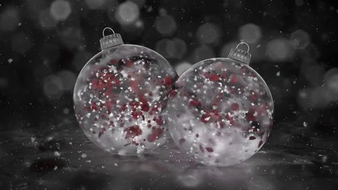 Two Rotating Christmas White Ice Glass Baubles snow red petals background loop Stock Footage 82435247