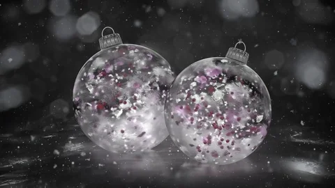 Two Rotating Christmas White Ice Baubles snow colorful petals background loop Stock Footage 82435378