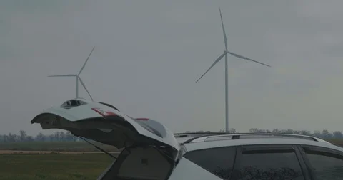 Two Rotating Wind Generator In Front Of A Car. . Eco Friendly Concept Stock Footage 123712446