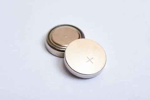 Two round batteries on a white background Stock Photos