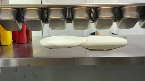 Two Round Flatbreads Placed on Food Preparation Counter Ready for Fresh Stock Footage 345170972