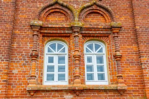 Two rounded windows on old red brick wall Stock Photos