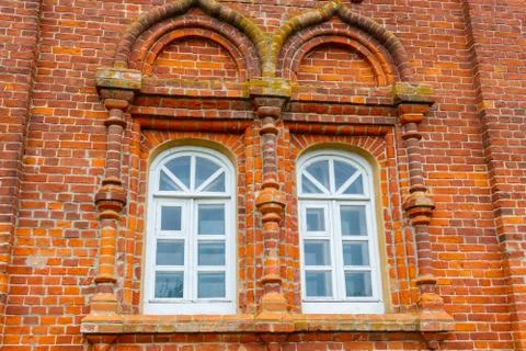 Two rounded windows on old red brick wall Stock Photos