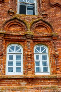 Two rounded windows on old red brick wall Stock Photos