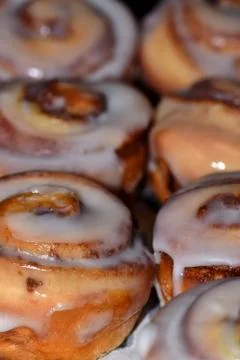 Two rows of cinnamon scrolls. Stock Photos