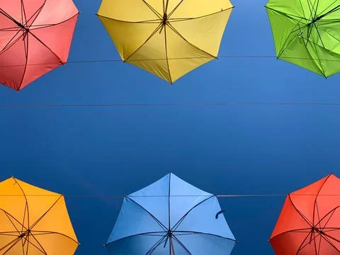Two rows of colored umbrellas overhead. Stock Photos