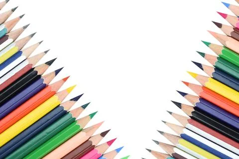 Two rows of different colored wood pencil crayons placed before a white backg Stock Photos