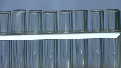 Two rows of glass tubes in a support dolly shot Stock Footage 77209169