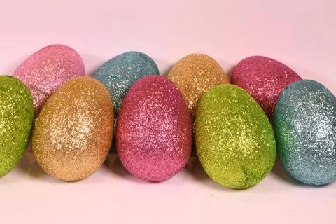 Two rows of Glittering colored Easter Eggs Stock Photos