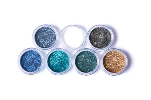 Two rows of metallic glitters in jars Foto stock