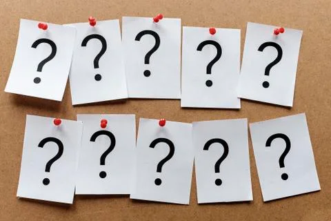 Two rows of question marks pinned to a board Stock Photos