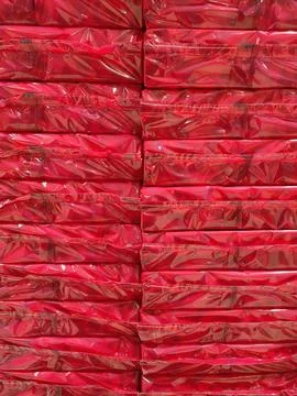 Two rows of red cellophane packages Stock Photos