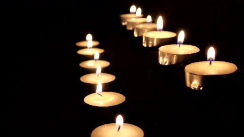 Two Rows Of Tealight candles with a dark black background 스톡 동영상 132274794