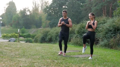 Two runner fit stretch exercises outdoor in park. Stretching legs muscle Stock Footage 142419517