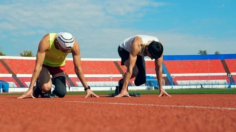 Two runners with artificial legs are practicing Stock Footage 118613991