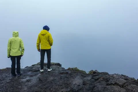 Two Runners in Bright Jackets Standing on Rocky Mountain in Iceland Stock Photos