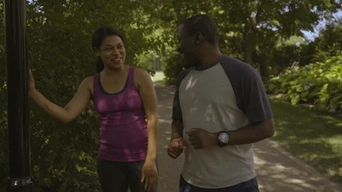 Two Runners Meet while Stretching in Park 2 Stock-Footage 91981695
