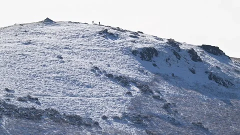 Two runners on a snow-covered Hope Bowdler Hill, Shropshire, UK. March 3 2024 Video stock 278605935