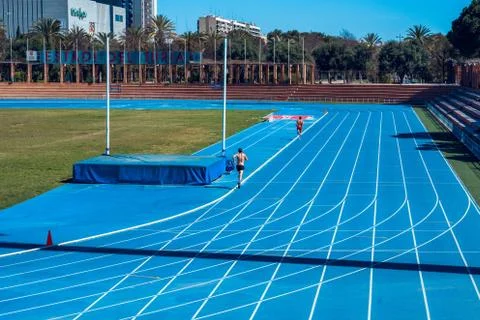 Two runners on the track. Running track at Rio Turia park in Valencia city. Stock Photos