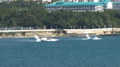 Two of Russian Be-103 light amphibian aircraft sail like boat in waters of Bay. Stock Footage 121532637