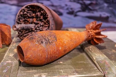 Two rusted cylindrical objects on a metal surface, possibly an old containe.. Stock Photos