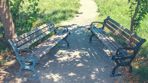 Two rustic benches facing each other, inviting connection, shared conversatio Stock Photos