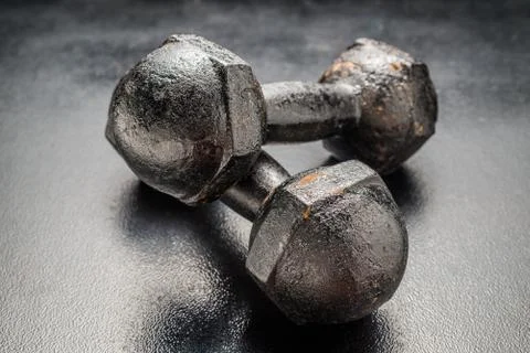Two Rusty dumbbell on black  background Stock Photos