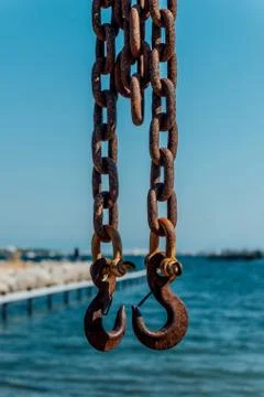 Two Rusty Iron Hooks on the chains Stock Photos