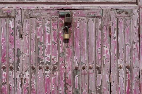Two rusty padlock locking a wooden door Stock Photos