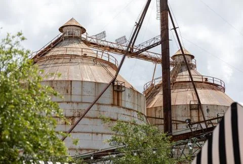 Two rusty round silos on a cloudy day Foto stock
