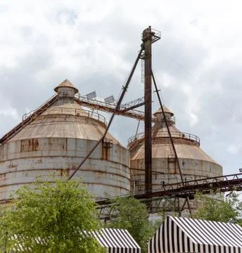 Two rusty round silos on a cloudy day Foto stock