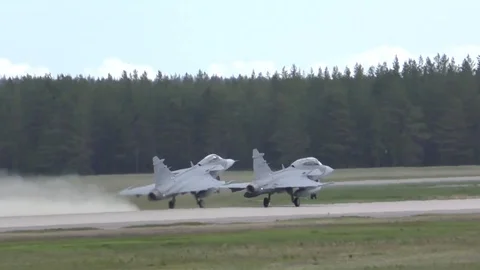 Two Saab JAS 39 Gripen take off in tandem during Arctic Challenge Exercise Stock Footage 109100481