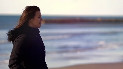 Two sad women hugging crying in front of the ocean Stock Footage 101052374