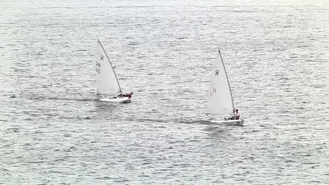 Two of a sailboat floating on the river Stock Footage 75616646