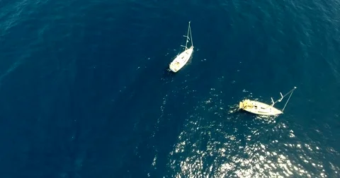 Two sailboats in the sea overhead shot. Aerial view of two yachts Stock Footage 64105559