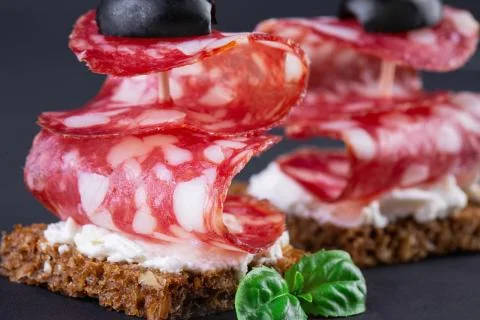 Two salami canapes Stock Photos