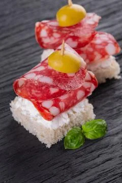 Two salami canapes Stock Photos