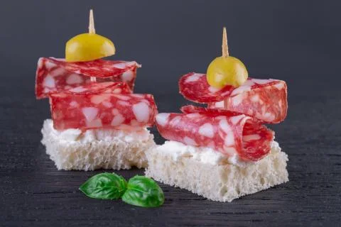 Two salami canapes Stock Photos