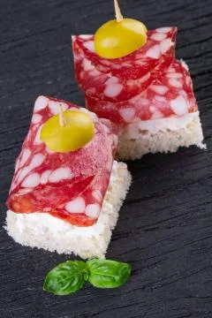 Two salami canapes Stock Photos