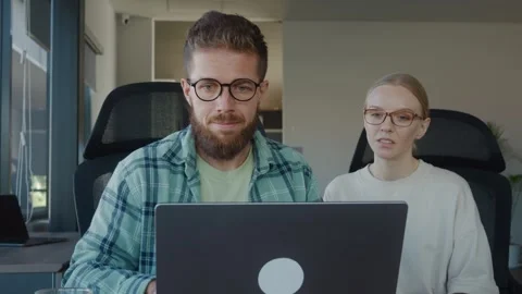 Two sales representative are collaborating on project, sharing ideas and working Stock Footage 312123619