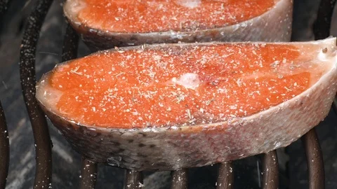 Two salmon steaks being fried on the grill dolly Video stock 94242099