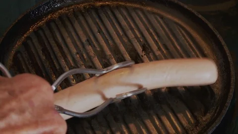 Two sausages cooking Stock Footage 112589847