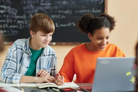Two school children using laptop computer in class Stock Photos