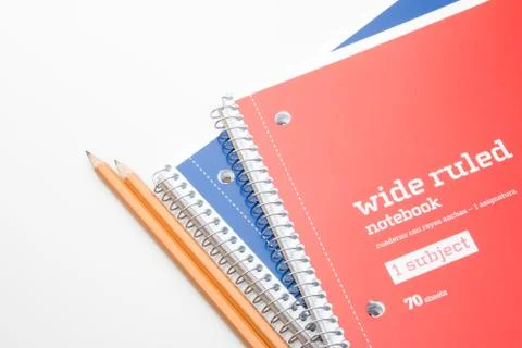 Two school notebooks and sharpened pencils on a white background. Stock Photos